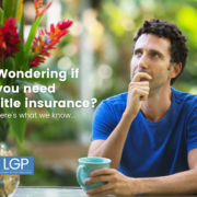 Thoughtful man in blue shirt with blue coffee cup wondering if he needs title insurance